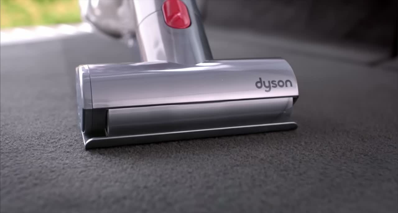 The Dyson V8 Absolute cordless vacuum being used around a home